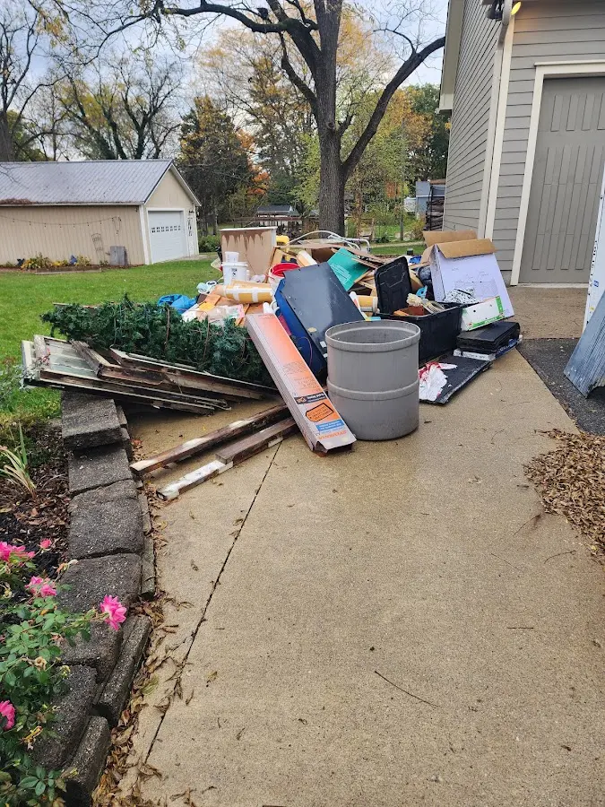 Dumpster being loaded with debris for 10 Yard Dumpster Rental in Girard